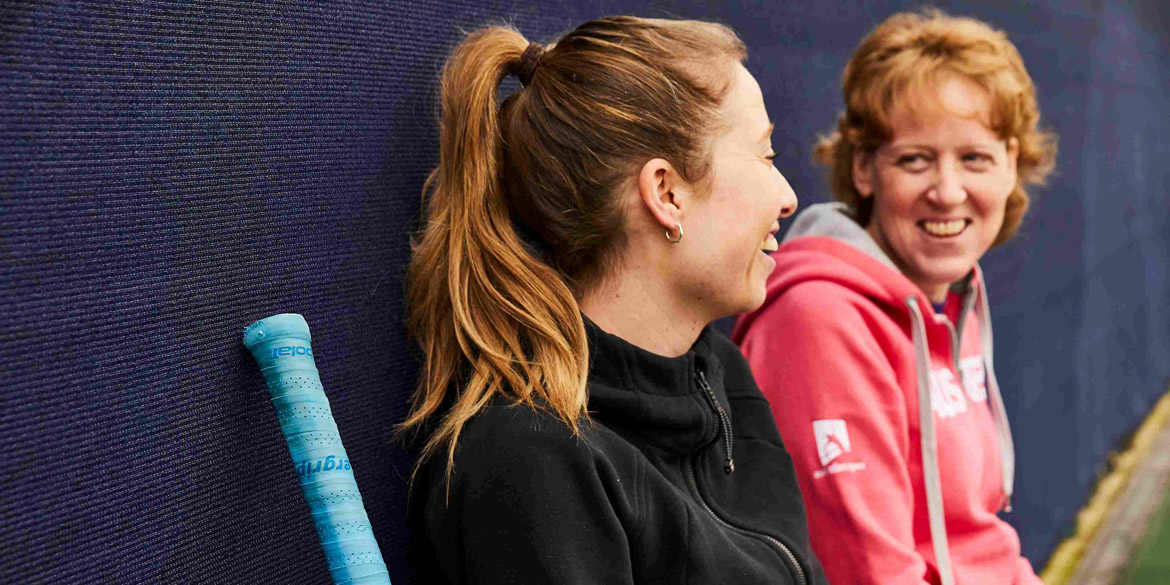 Female athletes sitting down having a chat Female athletes sitting down having a chat
