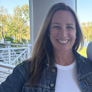 Lisa Zimmerman smiling at the camera in a white top with jean jacket