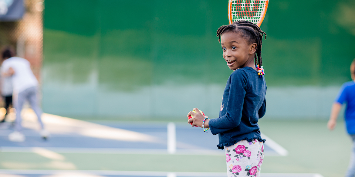 Young child holding a tennis racquet
