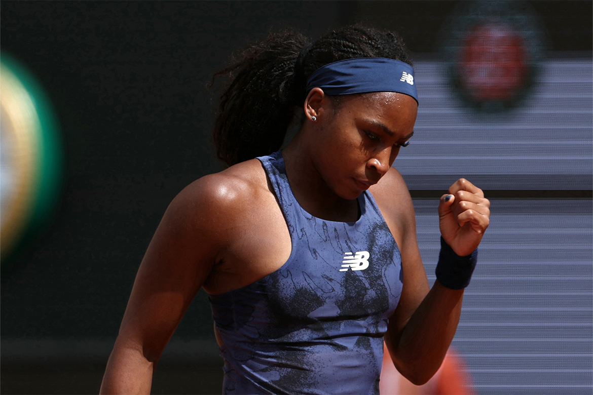Tennis player celebrating point on court.