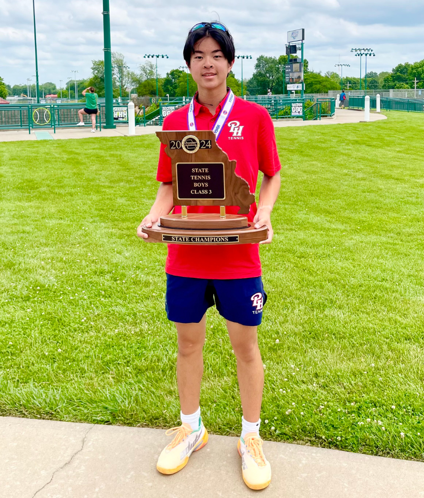 Pembroke Hill boys' tennis player Nicholas Dunn holds up the MSHSAA championship trophy.
