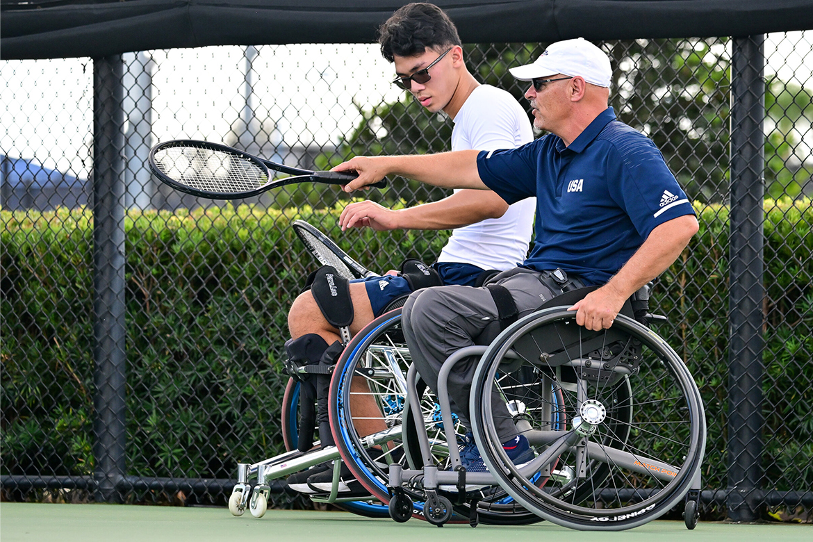 A coach instructs a player.