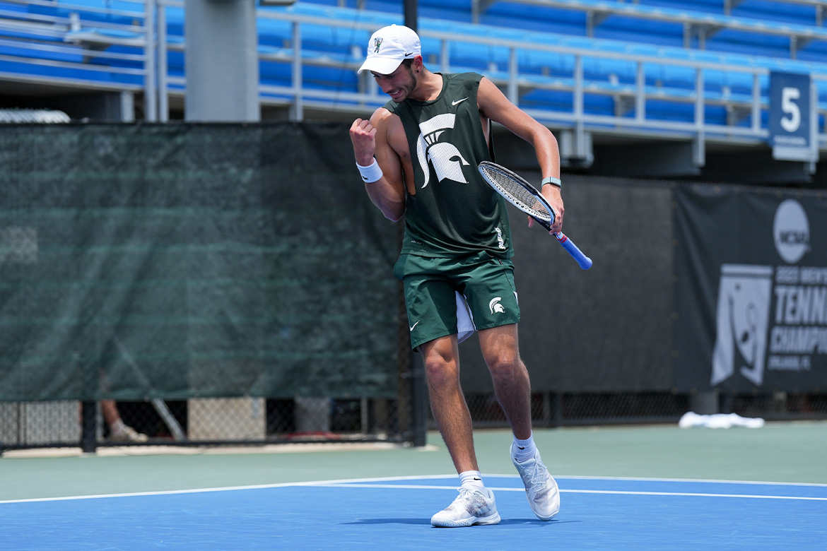 Tennis player celebrating point on court.