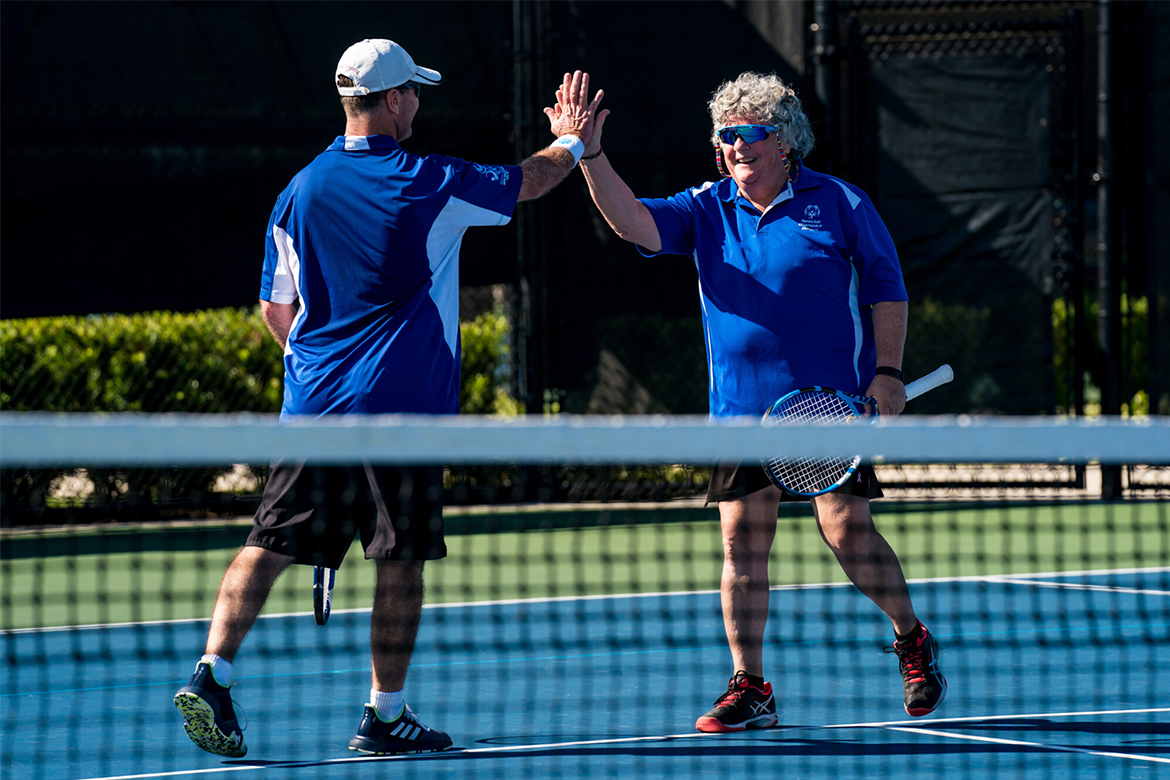 Two players high-five each other.