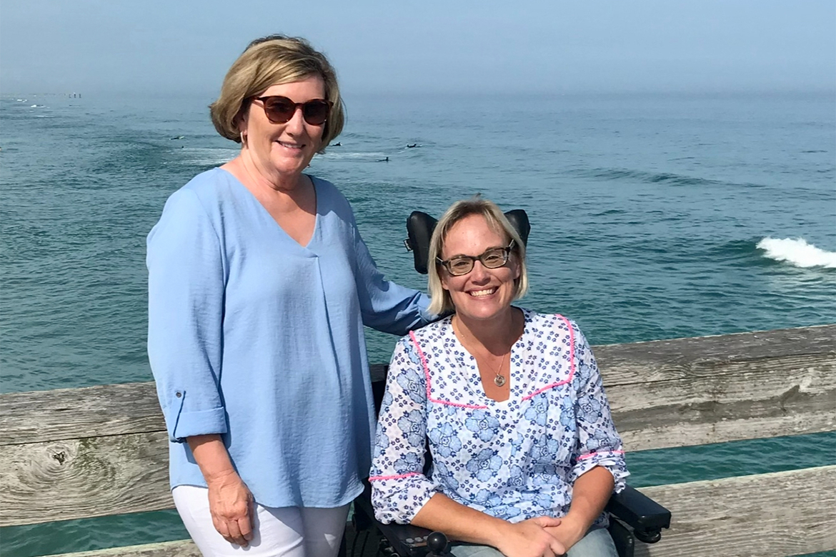 Two women pose for a photo.