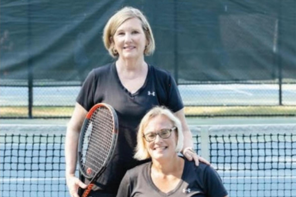 Two women pose for a photo.
